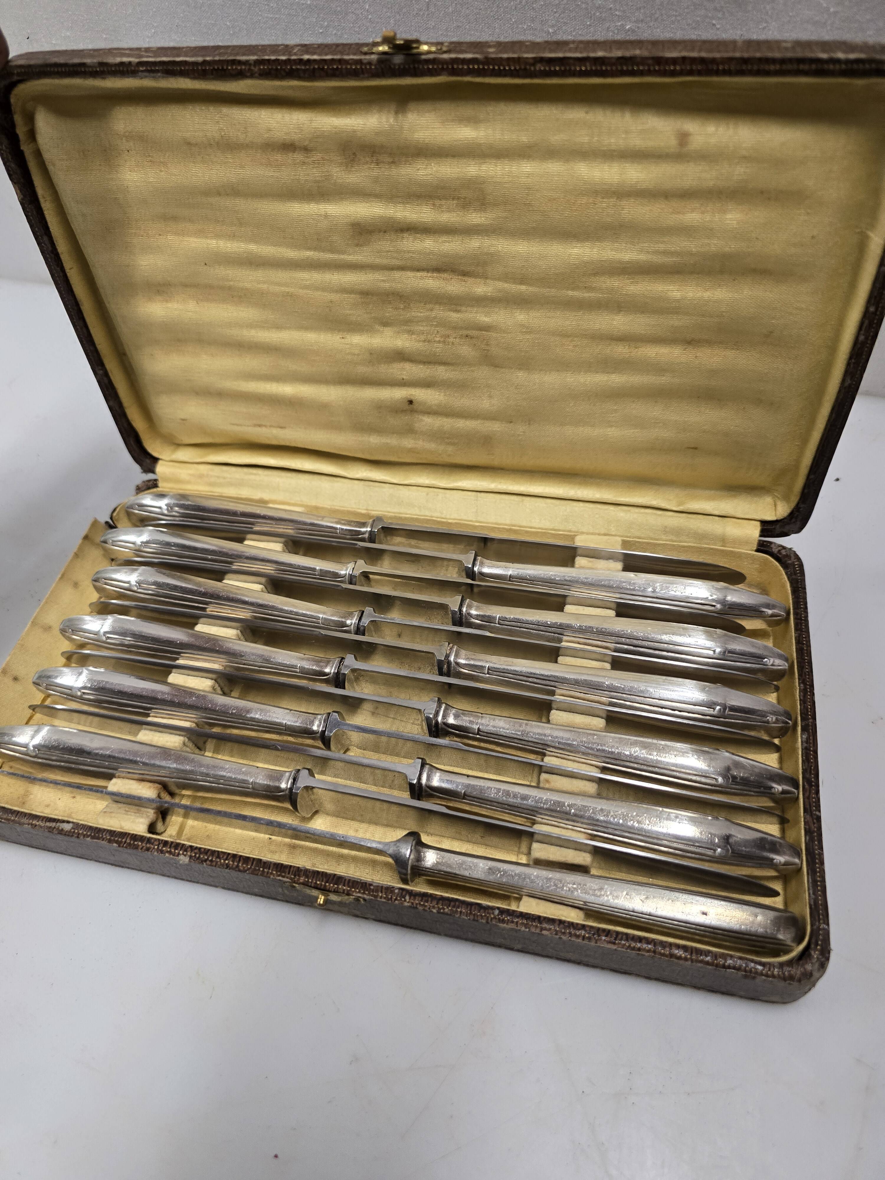 12 silver-plated knives from the mid-20th century