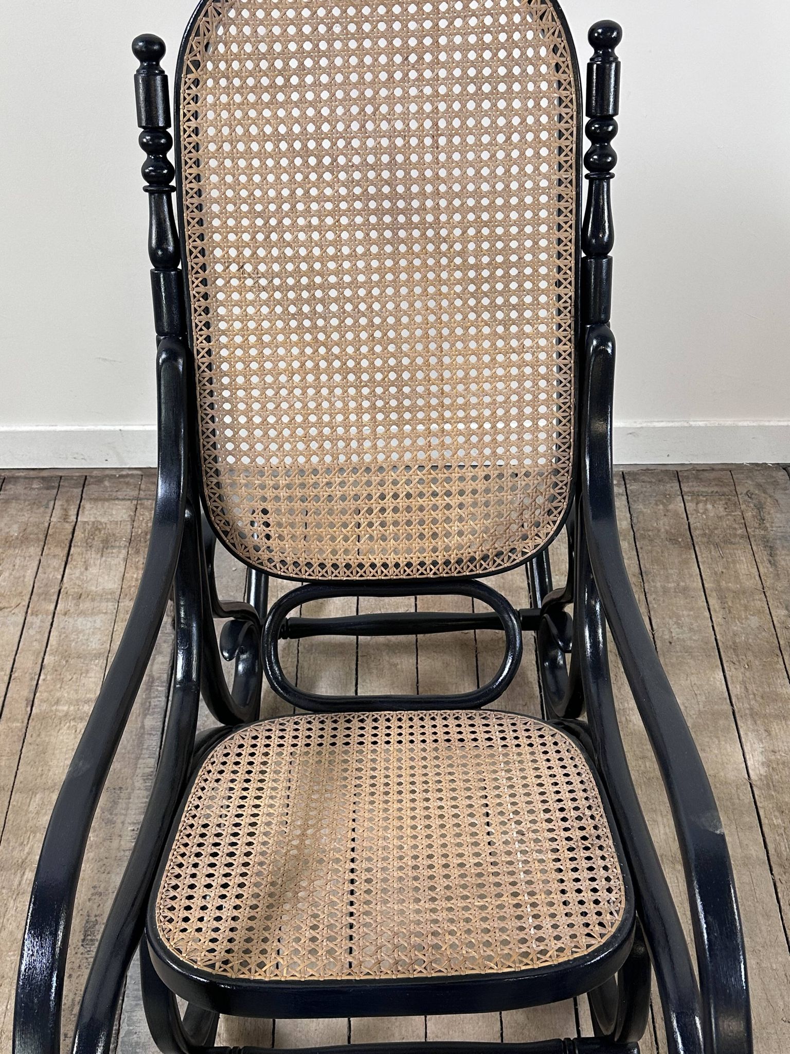 Rocking chair in blackened curved wood and cane, 1900s