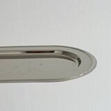 Small antique tray made of lightweight metal.