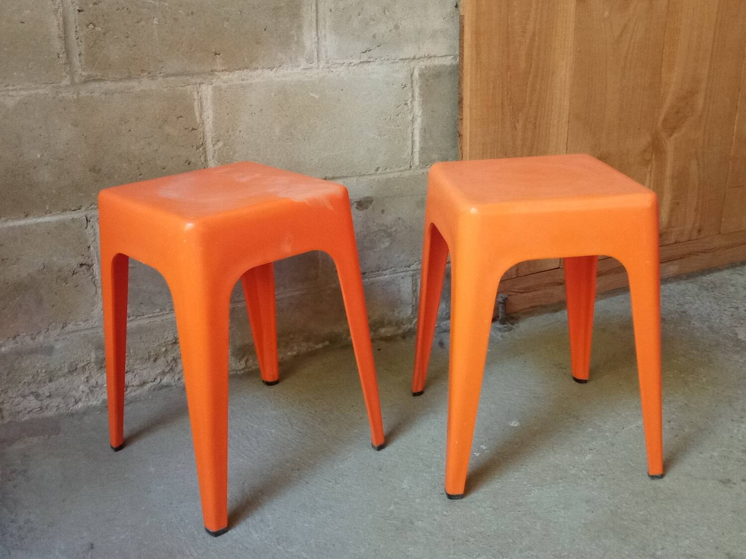 Pair of AMI stools in orange plastic
