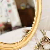 Oval wall mirror in gilded wood