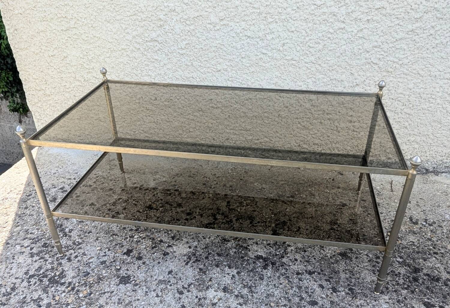 Vintage coffee table with gold metal and smoked glass, featuring 2 tiers in Hollywood style.