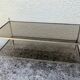 Vintage coffee table with gold metal and smoked glass, featuring 2 tiers in Hollywood style.