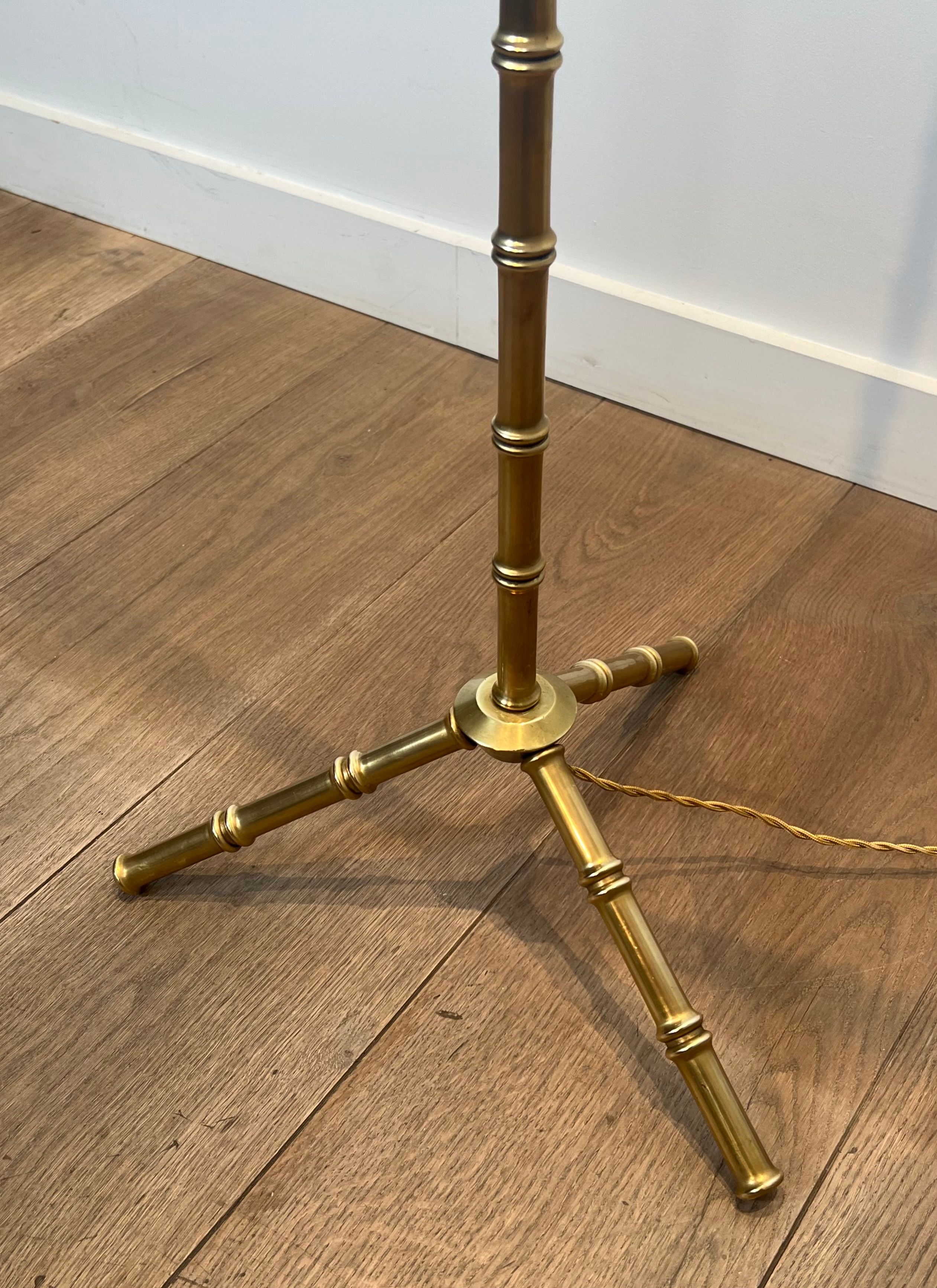 Pair of parquet floor lamps in faux-bamboo style in bronze and brass by Jacques Adnet.