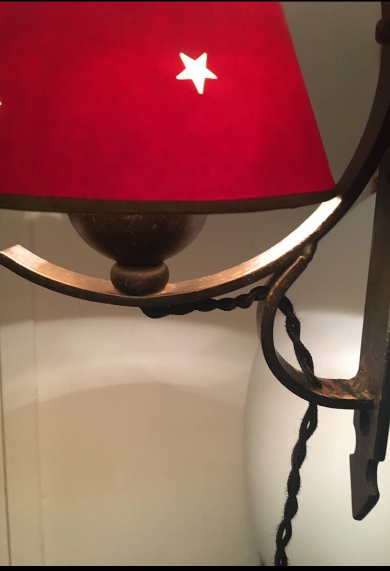 Two wrought iron wall lights, fabric cable.