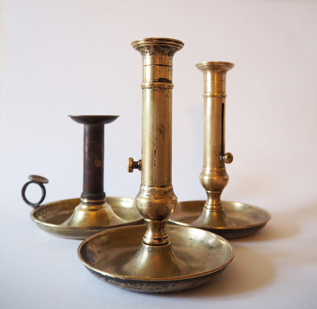 Set of three old brass candle holders