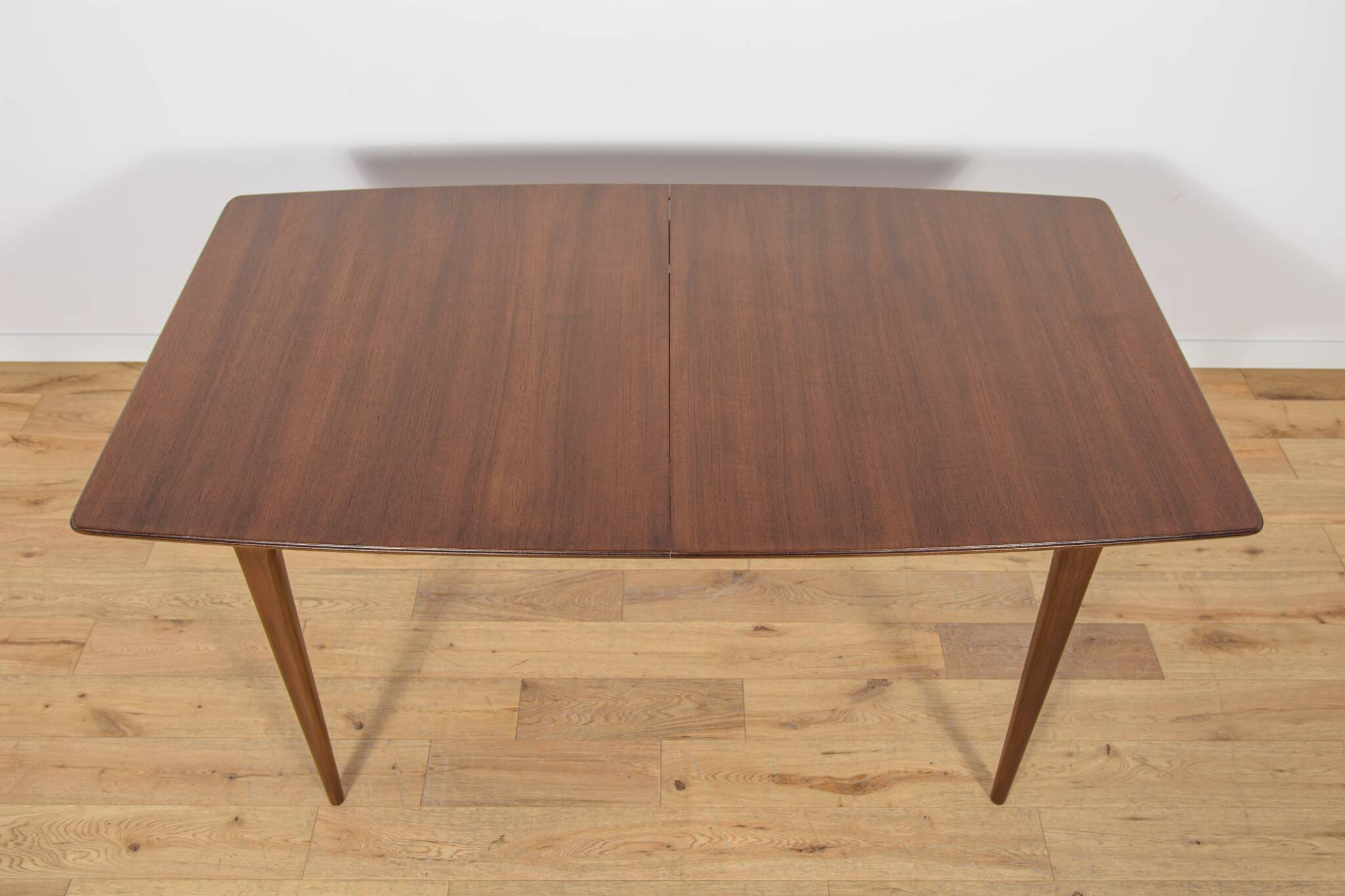 Extendable teak dining table in Mid-Century style from McIntosh, UK.