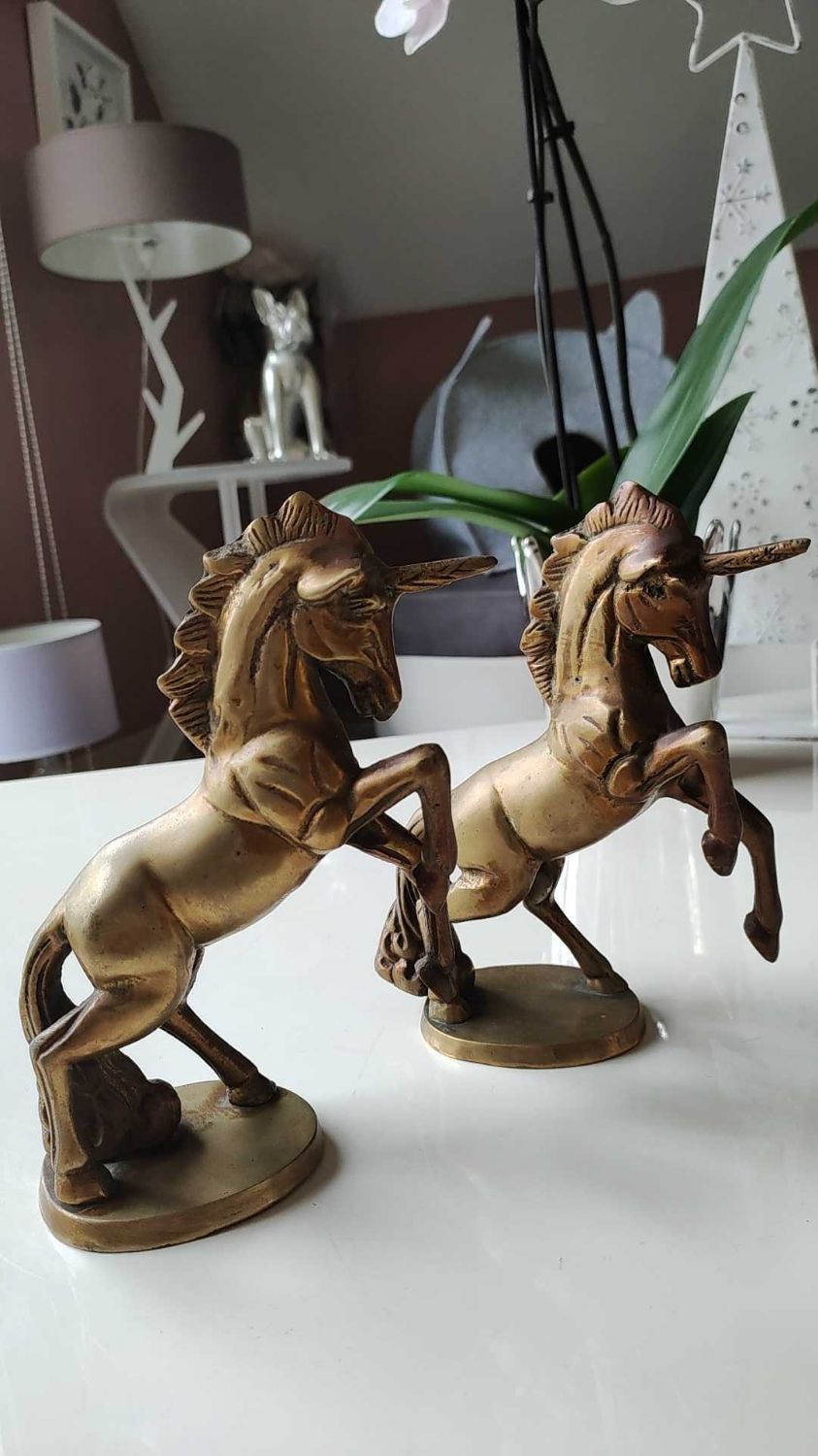 of greenhouse art deco bookends recancing unicorns. solid brass