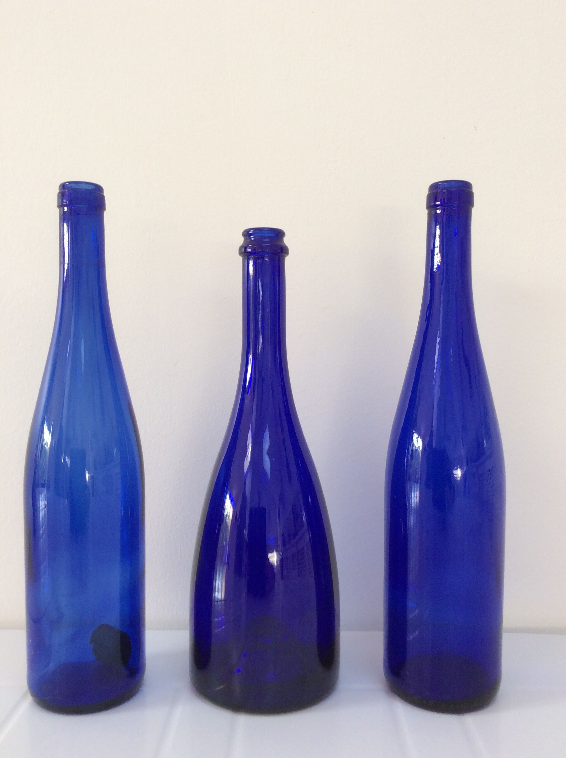 Decorative trio of old blue glass bottles