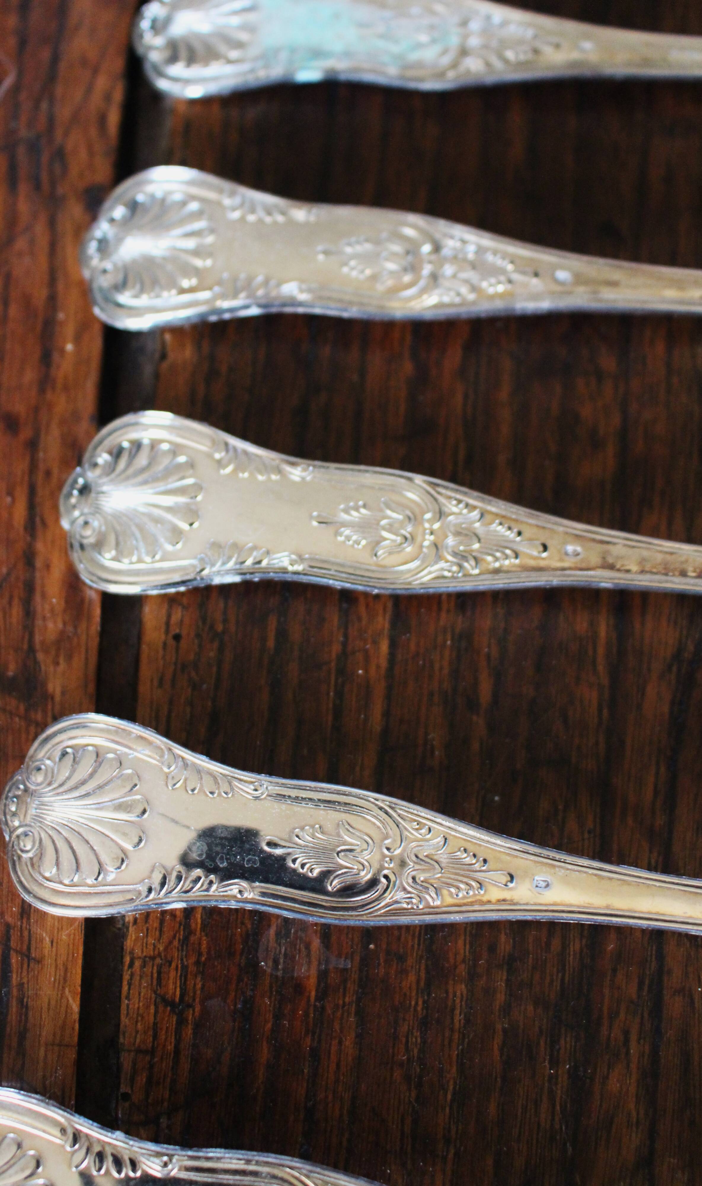 A set of 7 large metal shell spoons