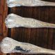 A set of 7 large metal shell spoons