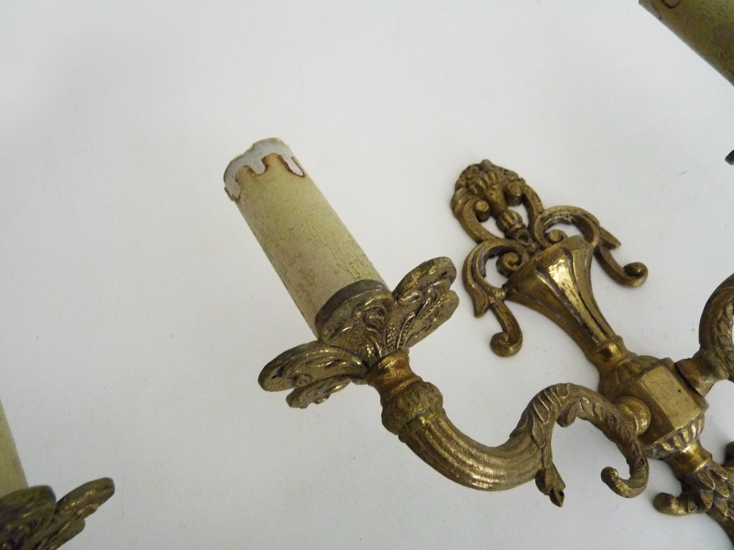 Pair of two-armed fire pot wall lights in gilded bronze.