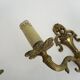 Pair of two-armed fire pot wall lights in gilded bronze.