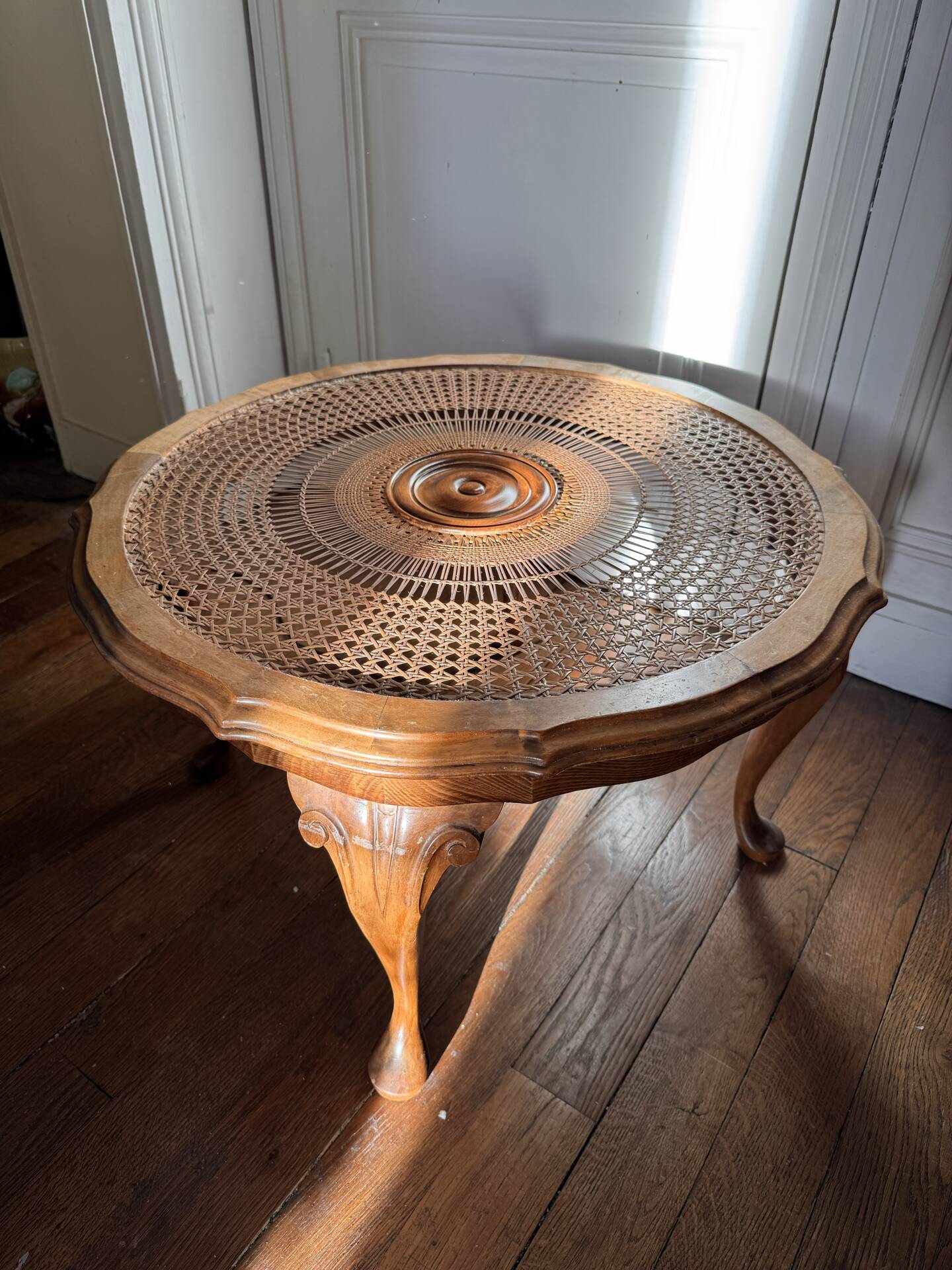 Round coffee table in Louis XV style, with sun cane and glass top.