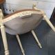 Louis XVI style bergère armchair in patinated wood