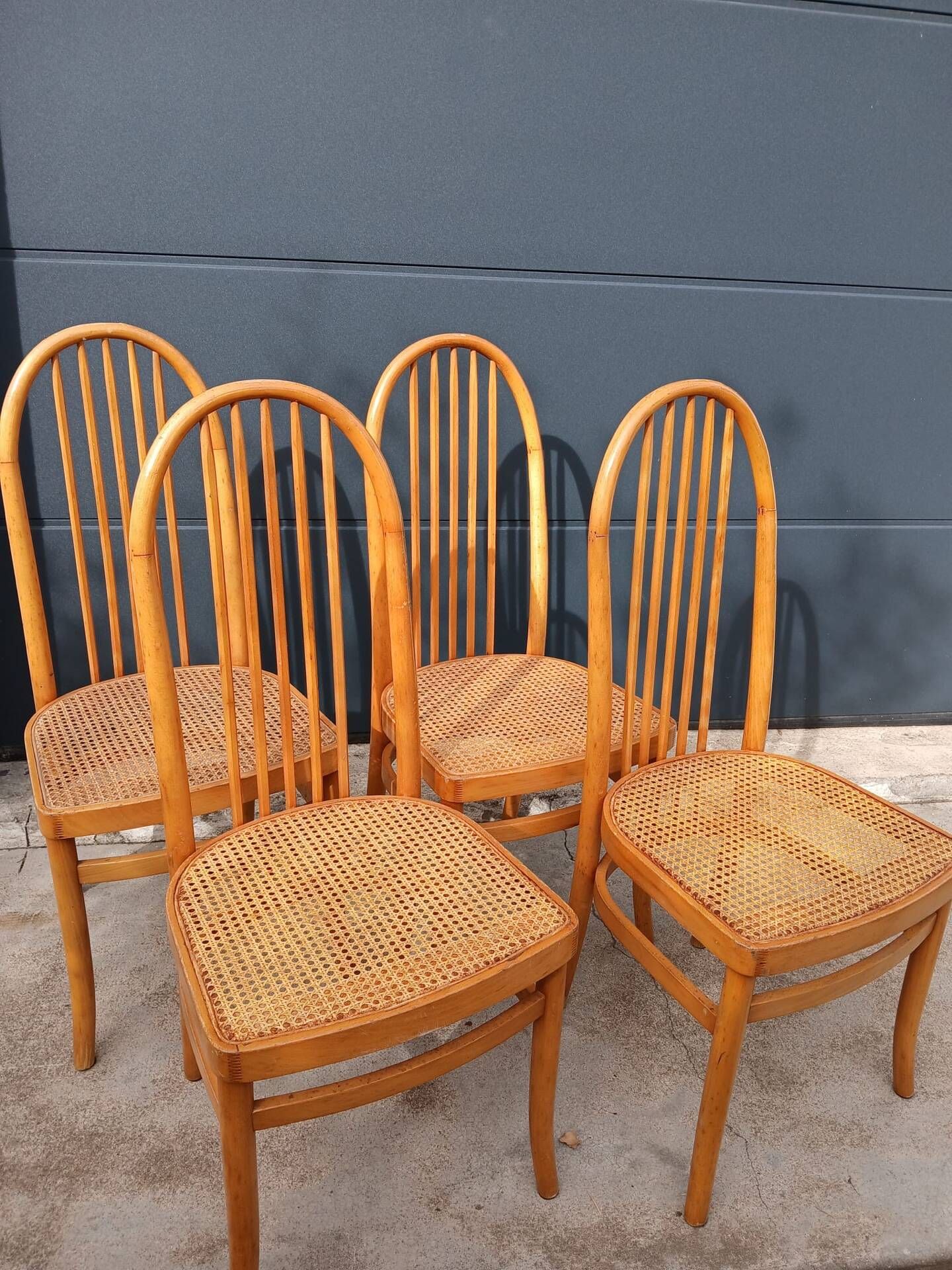 Set of 4 vintage Baumann chairs in honey wood and cane.