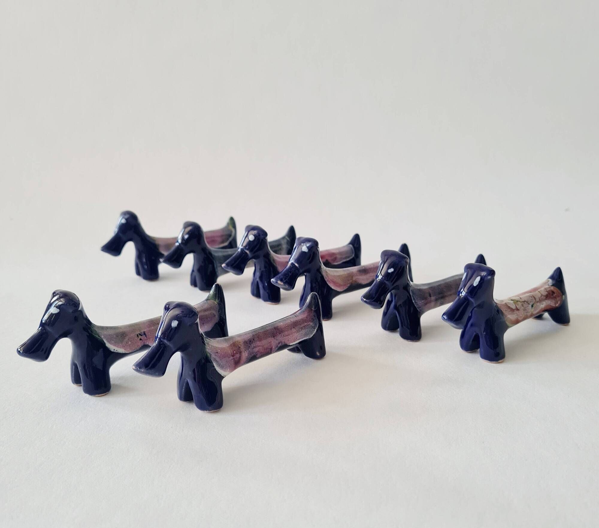 Set of 8 vintage ceramic knife rests, retro dog design.