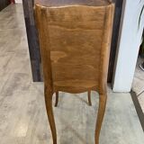 A bedside table with a drawer and a niche in Louis XV style.