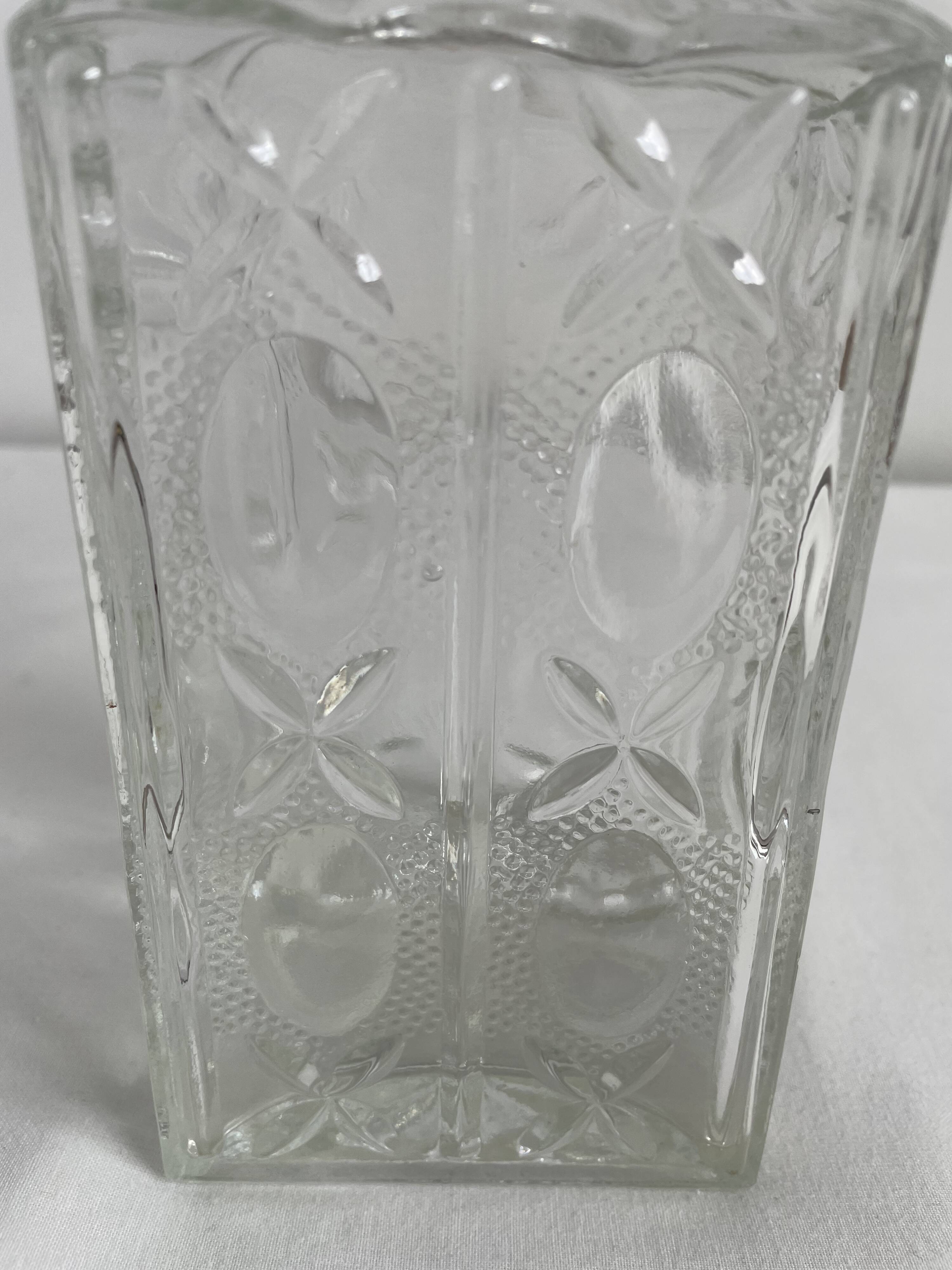 Molded glass carafe, 1960s-1970s, stylized flower decoration, oval, square base, stopper, rosette