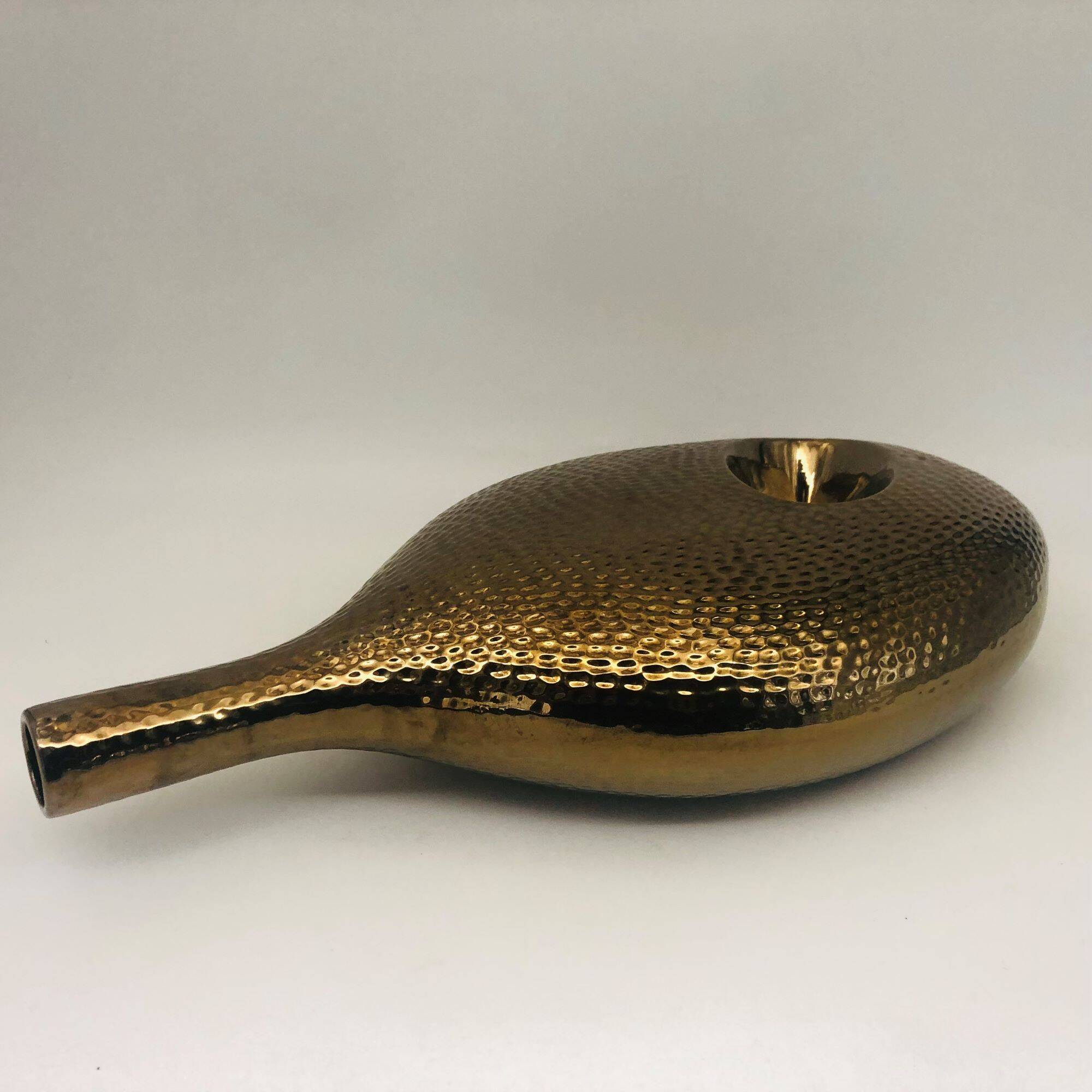 Golden ceramic vase.