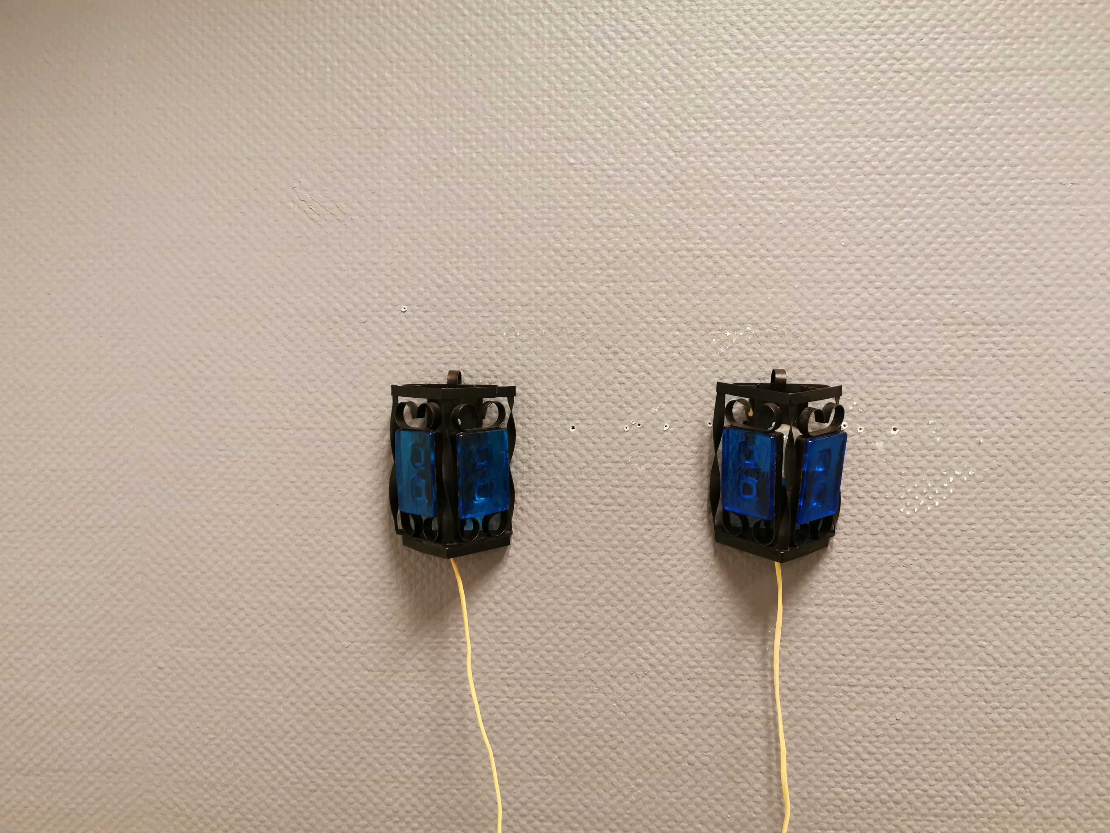 Wall lamps made of black cast iron and handmade thick pressed blue glass
