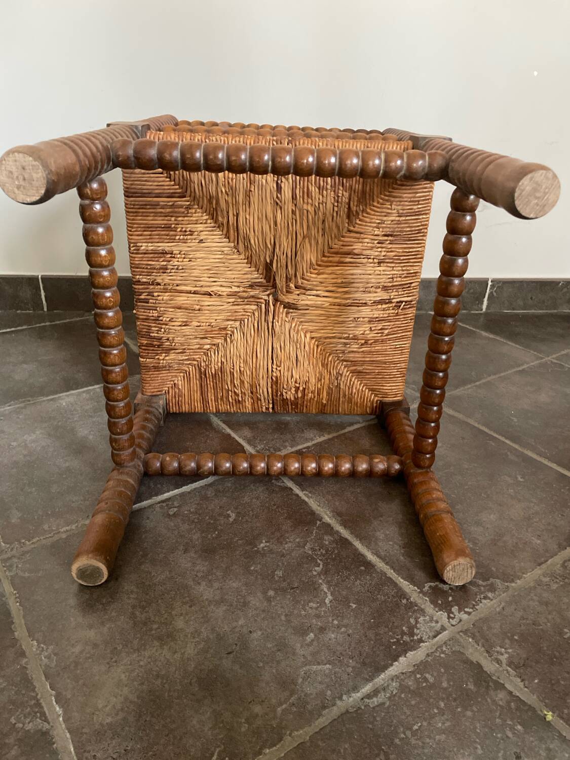 Old armchair, corner chair, made of wood and straw