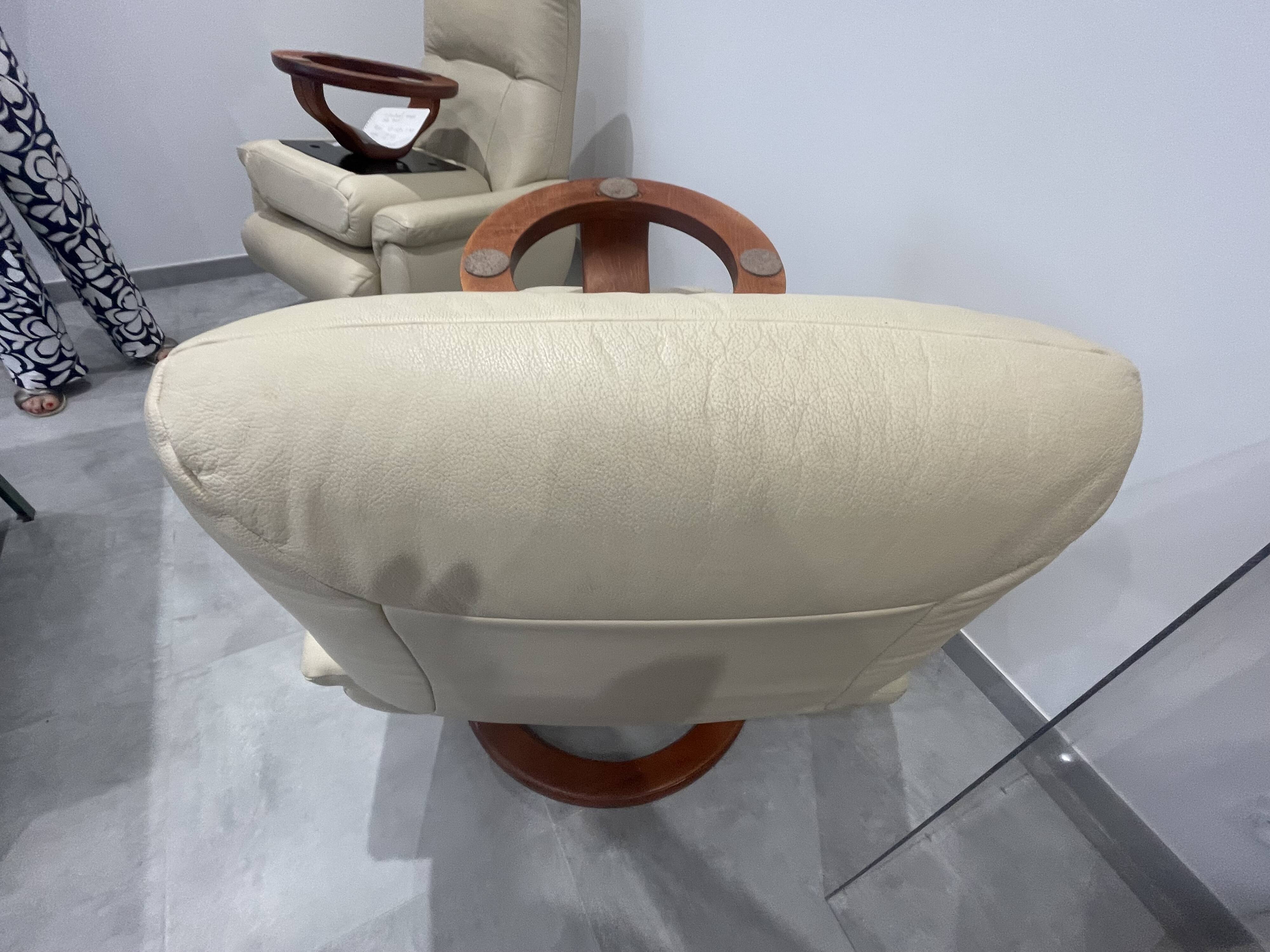 Pair of vintage leather armchairs with ottoman