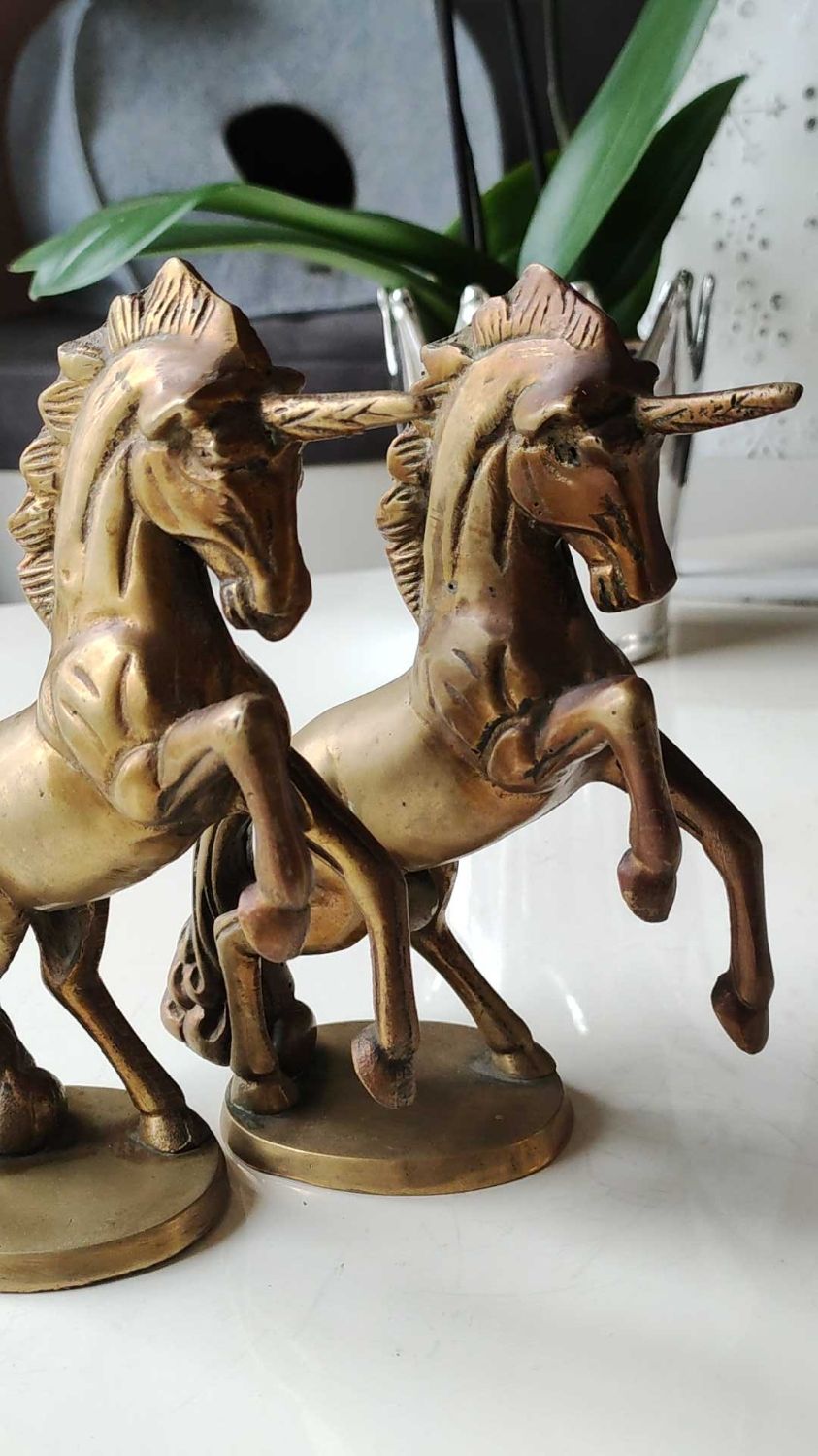 of greenhouse art deco bookends recancing unicorns. solid brass