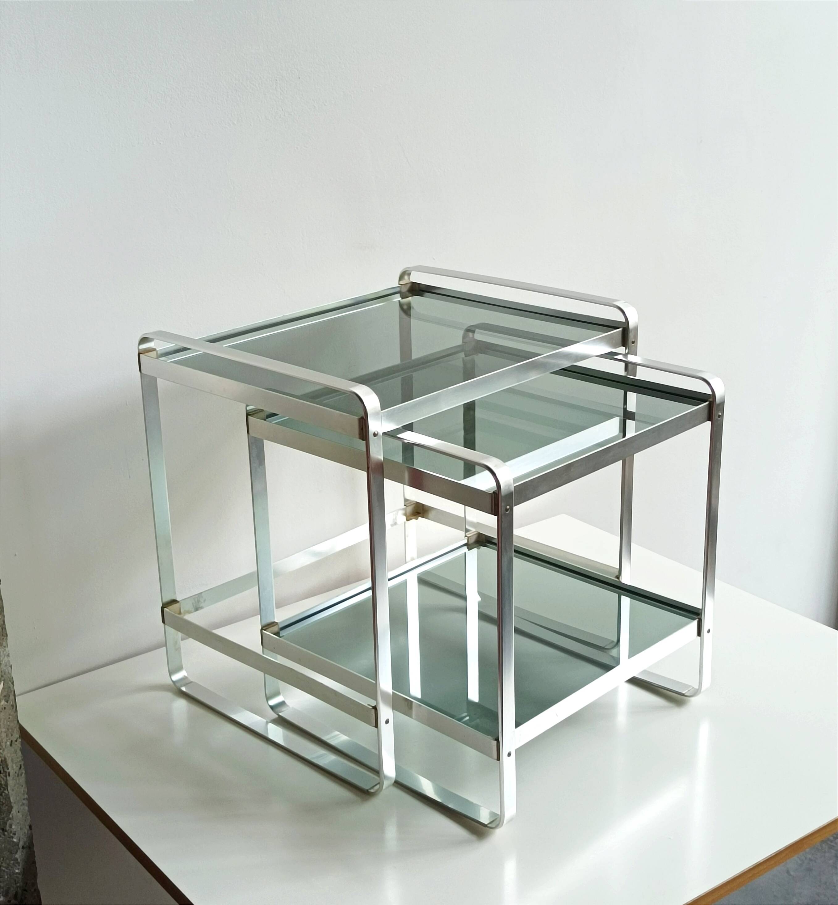 Nested tables in aluminium and smoked glass by Martini & Rossi, 1970s.