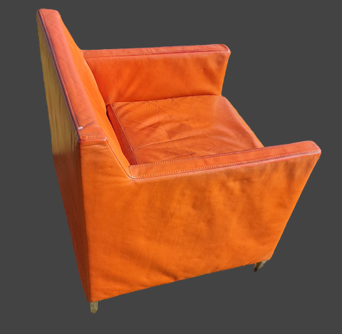 Pair of vintage orange leather armchairs