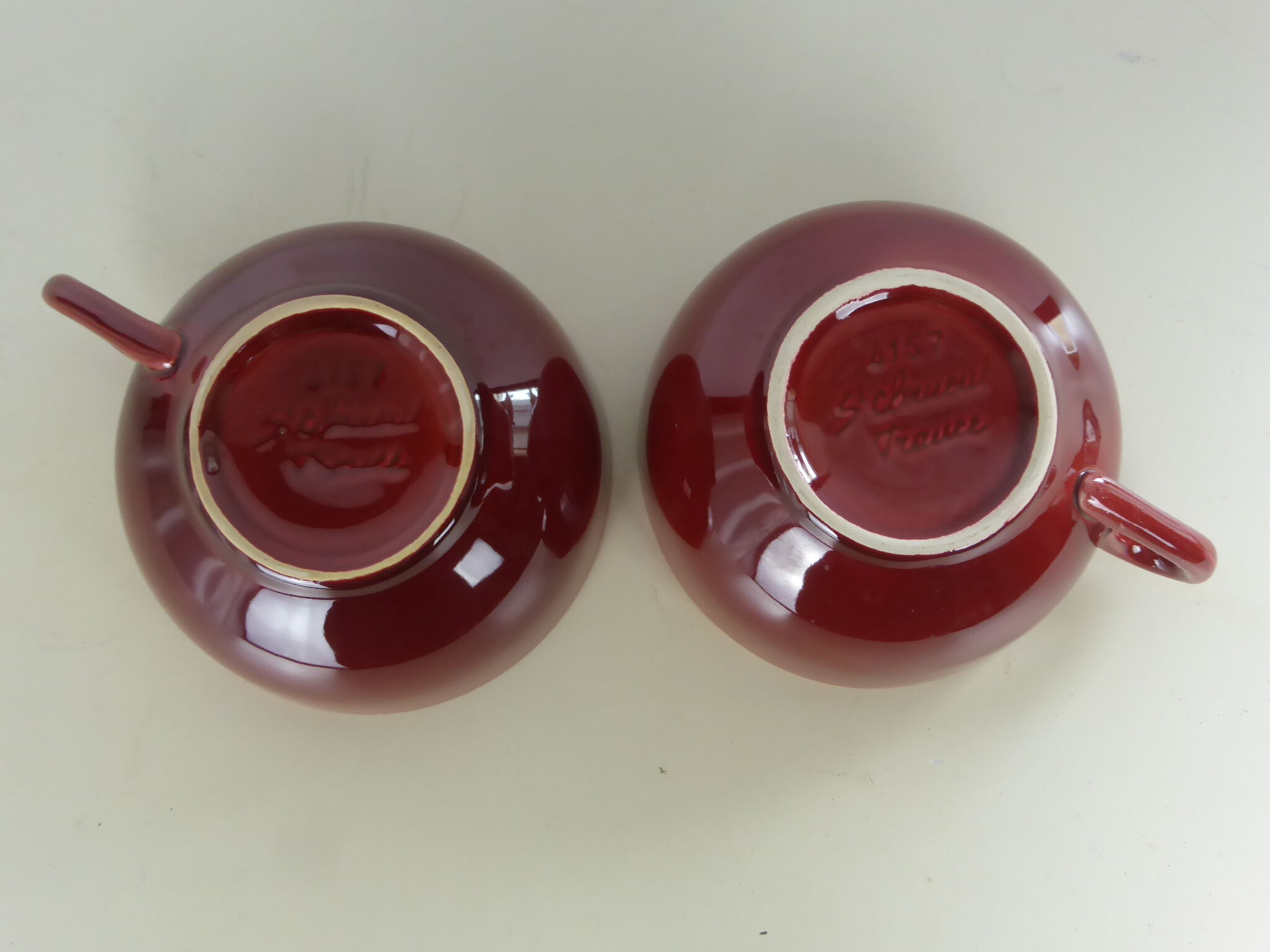 2 Old bowls with ox blood colored handle in St Clément earthenware