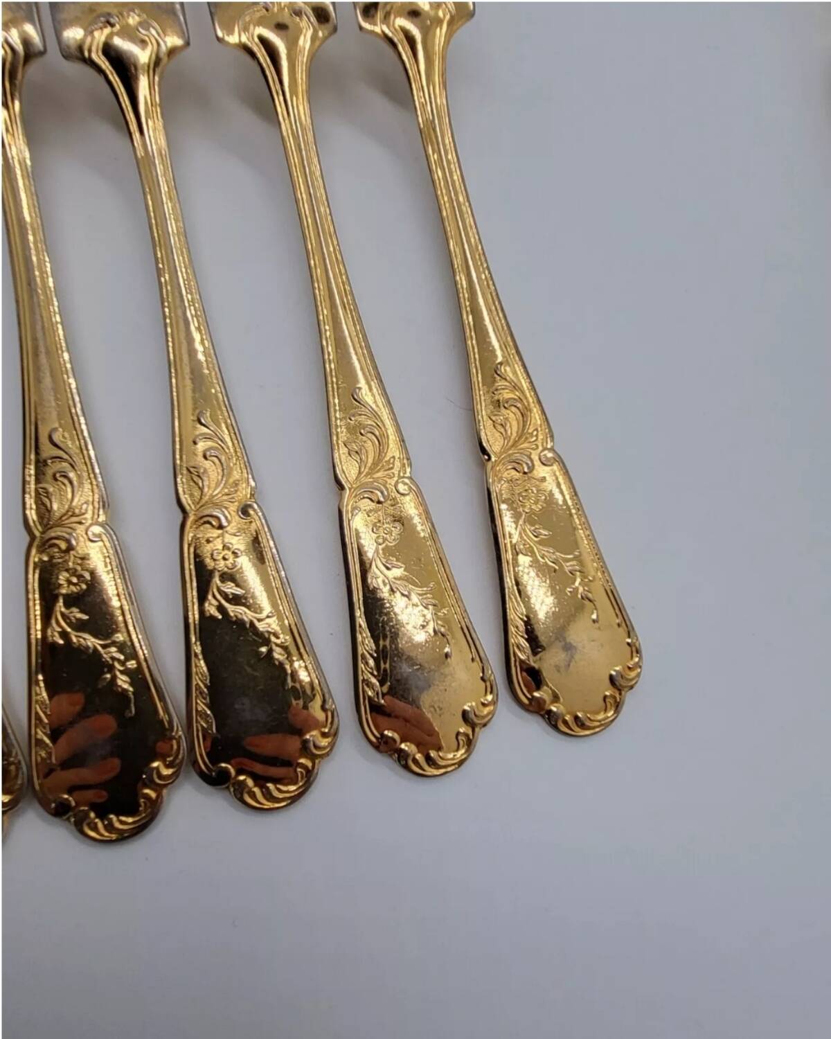 12 Table Forks in gold metal