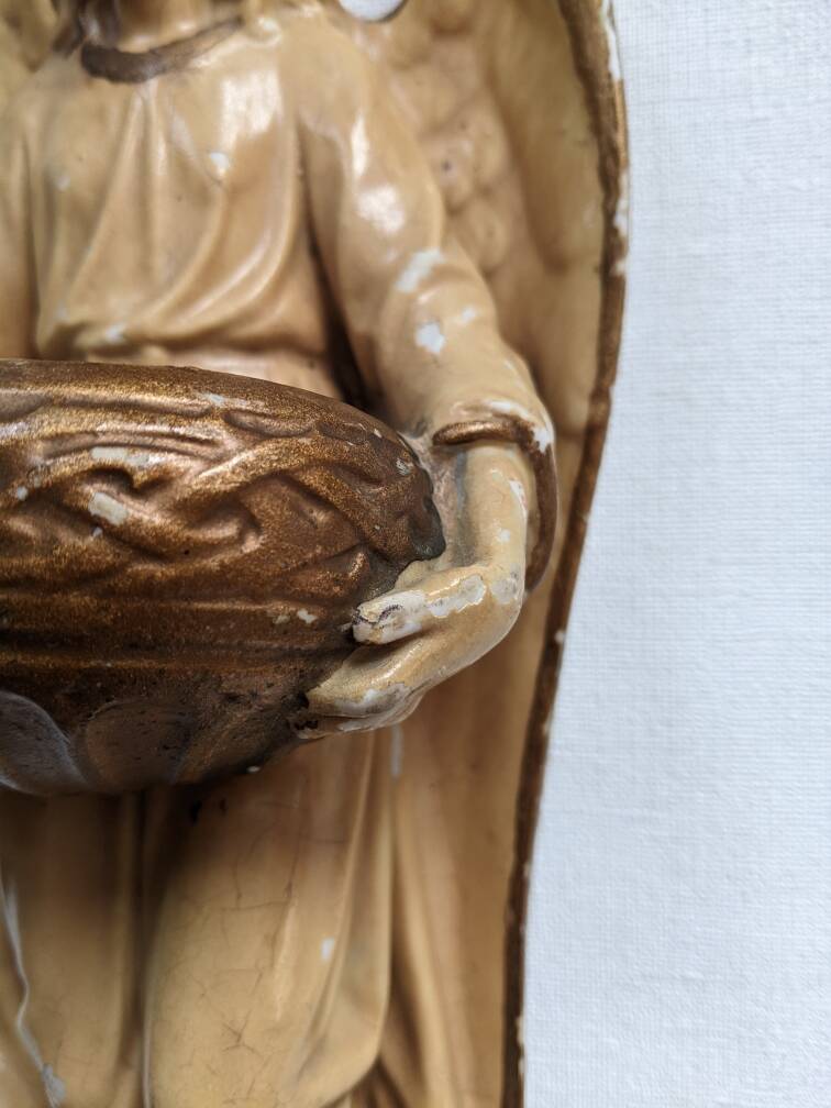 Antique ceramic holy water font with winged angel, religious object, country decoration