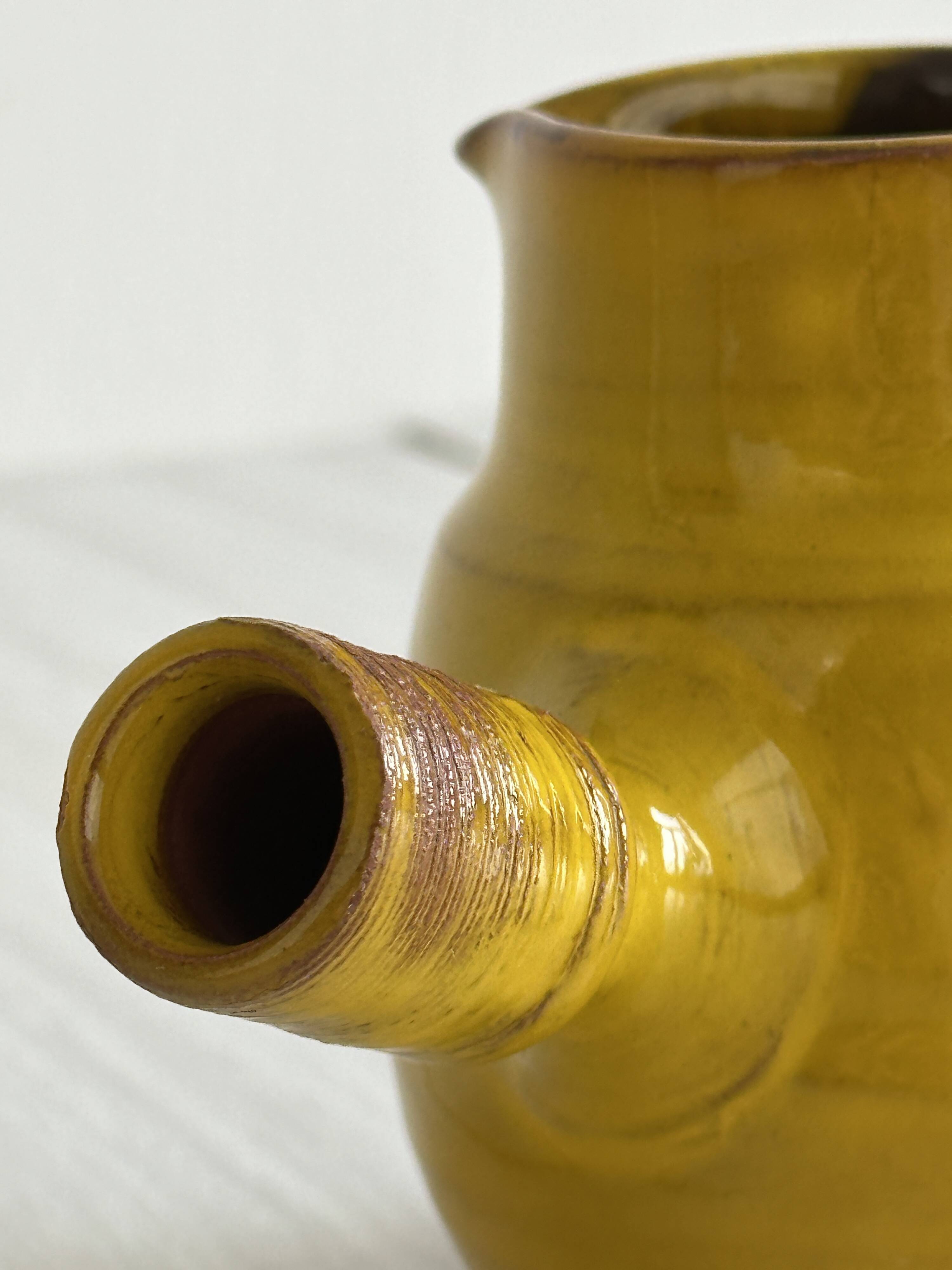 Yellow glazed ceramic sauce boat or milk jug