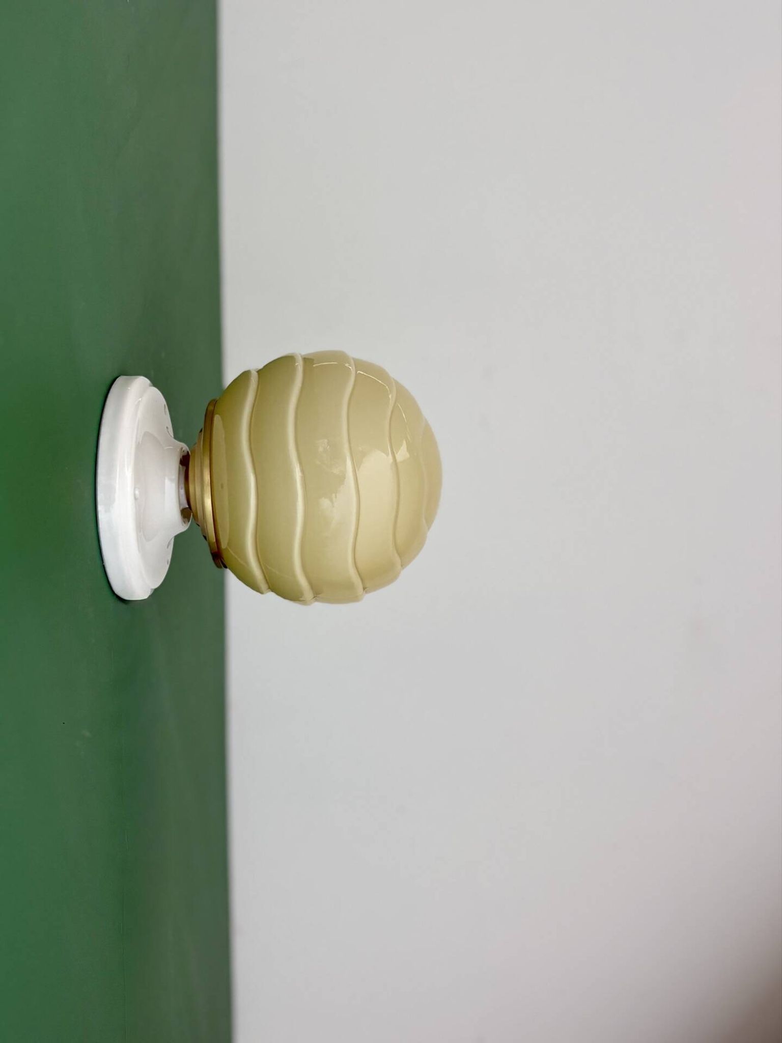 Vintage Art Deco globe wall light in pale yellow opaline.