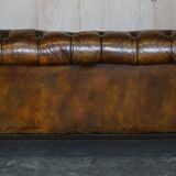 Victorian Chesterfield leather upholstered canapé with feather cushions.