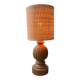 Antique table lamp with a carved wooden base.