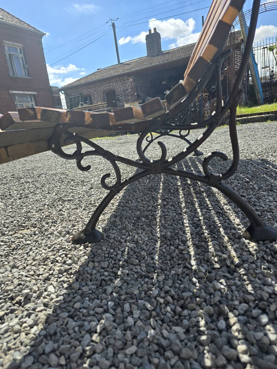 Wooden garden bench with cast iron base
