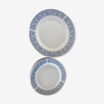 12 white porcelain plates with a blue eder