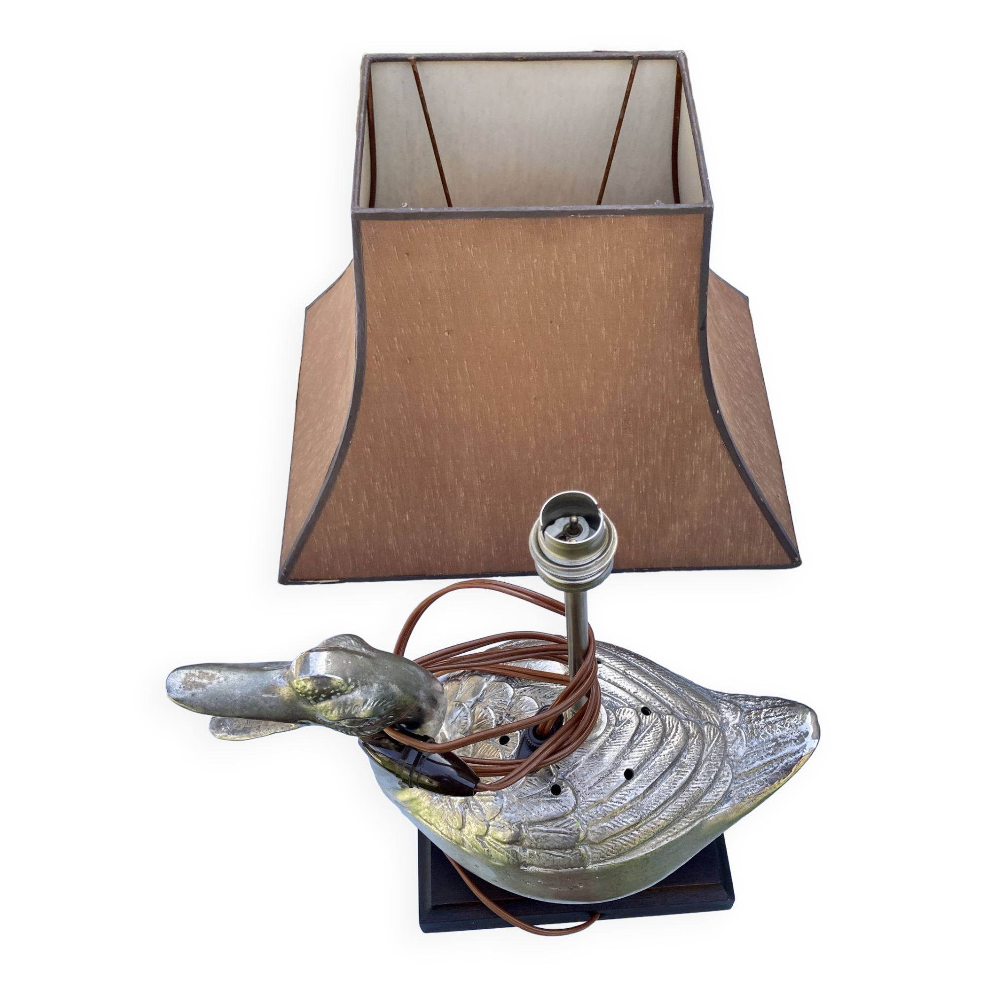 Old vintage lamp representing a duck in silver metal with wooden base