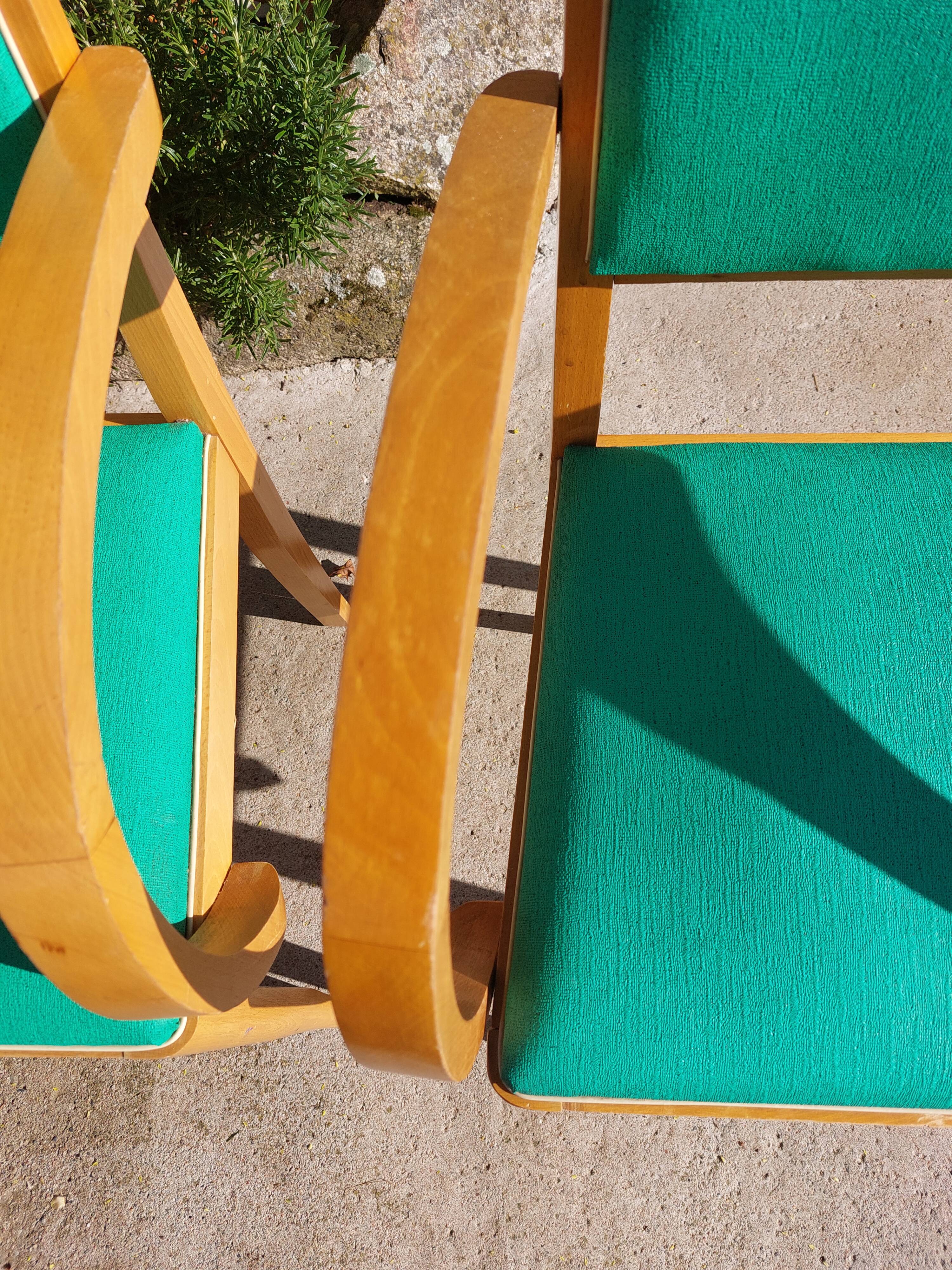 3 vintage bridge chairs with rounded armrests.