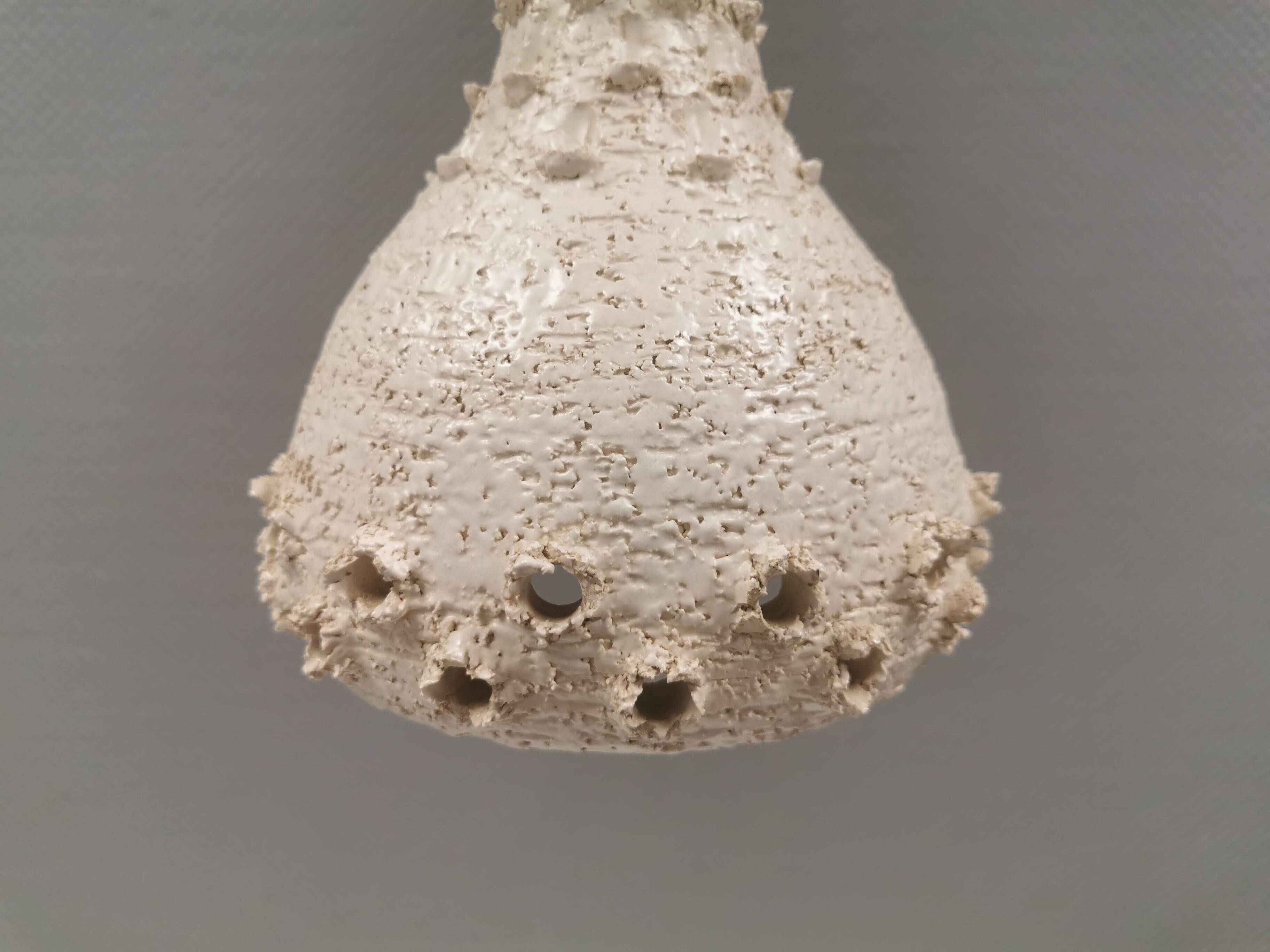 Ceramic hanging lamp in creamy white color that almost looks like a corral
