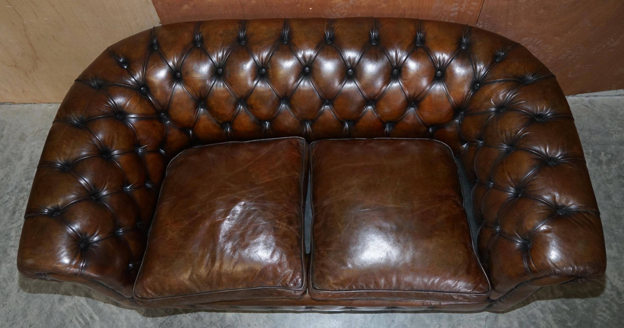 Restored leather Chesterfield sofa, walnut legs.