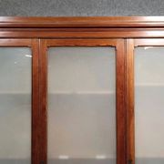 Large pine bookcase with three doors, fitted with frosted glass.