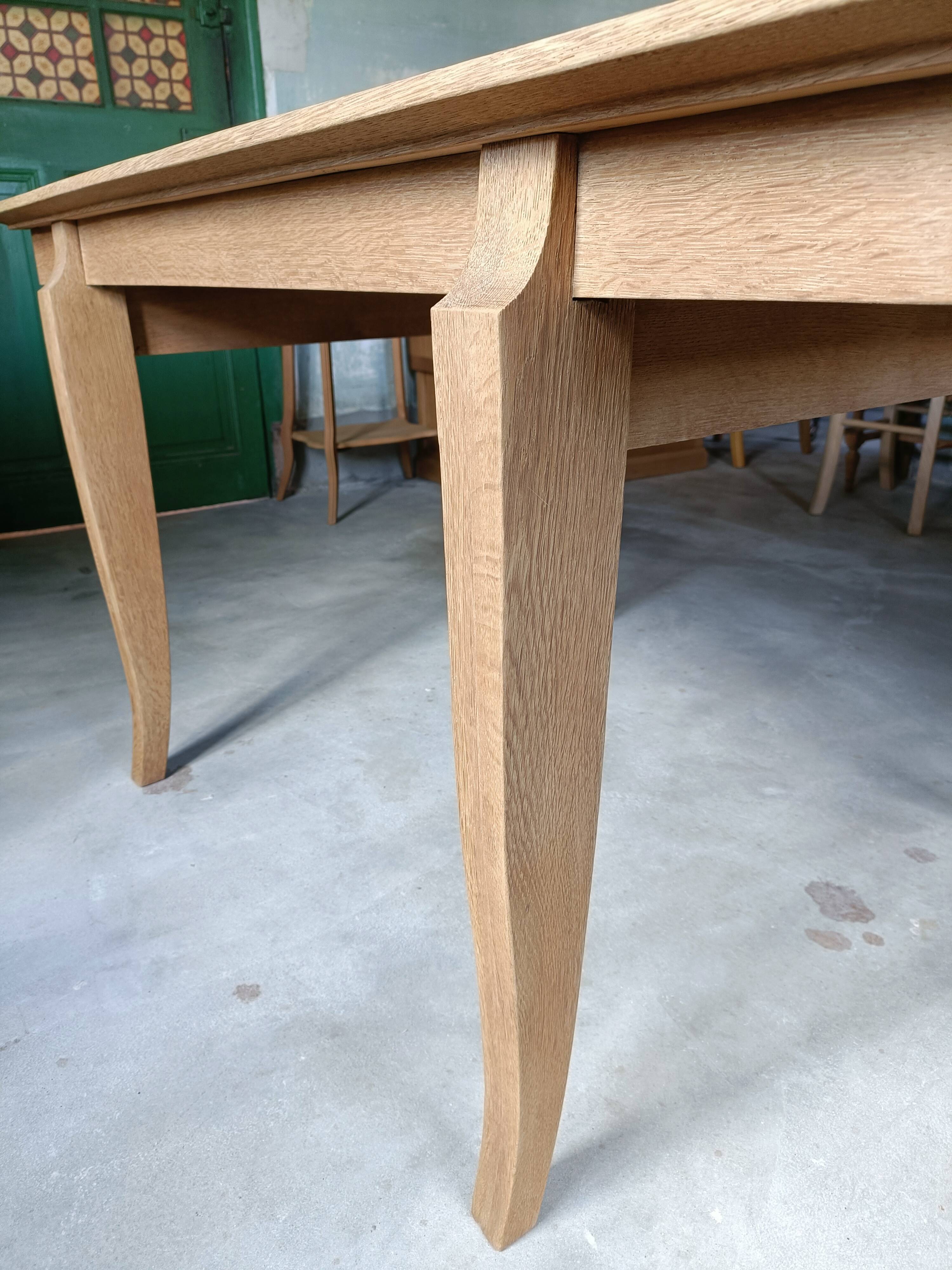 Oak dining table with a checkerboard top and extensions.