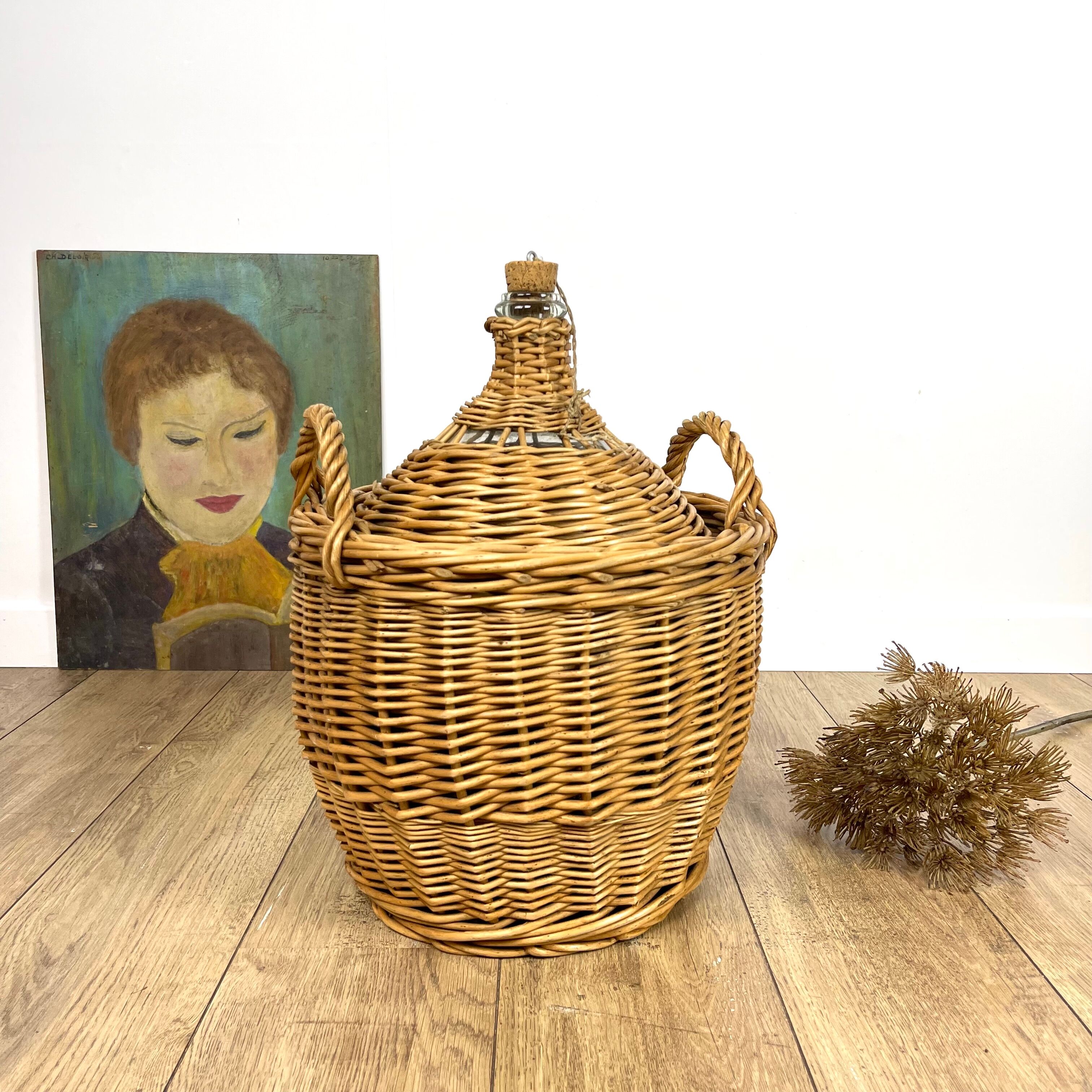Old demijohn in her wicker basket