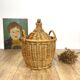 Old demijohn in her wicker basket