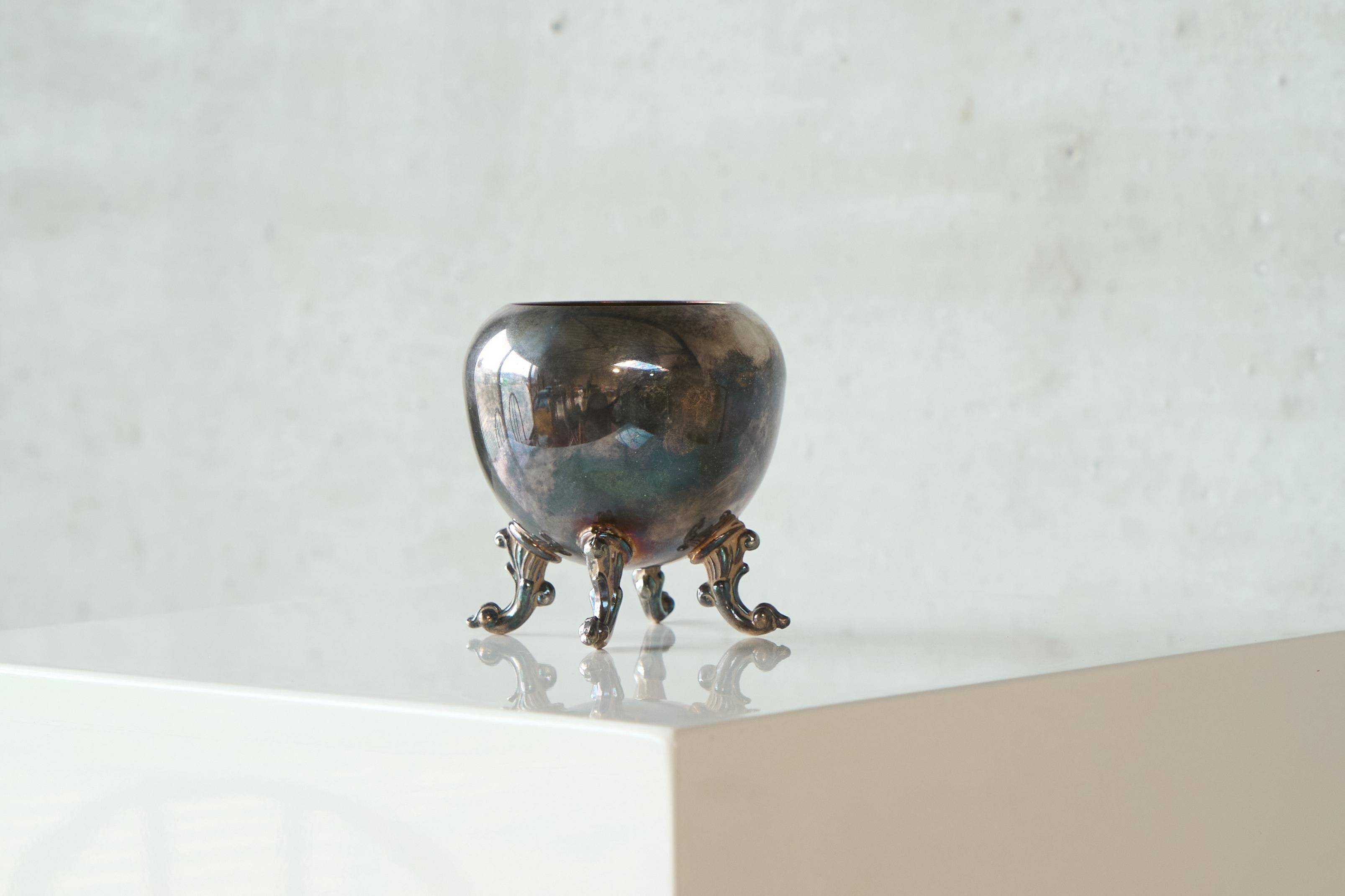 Neoclassical cup with a patinated and silvered copper base.