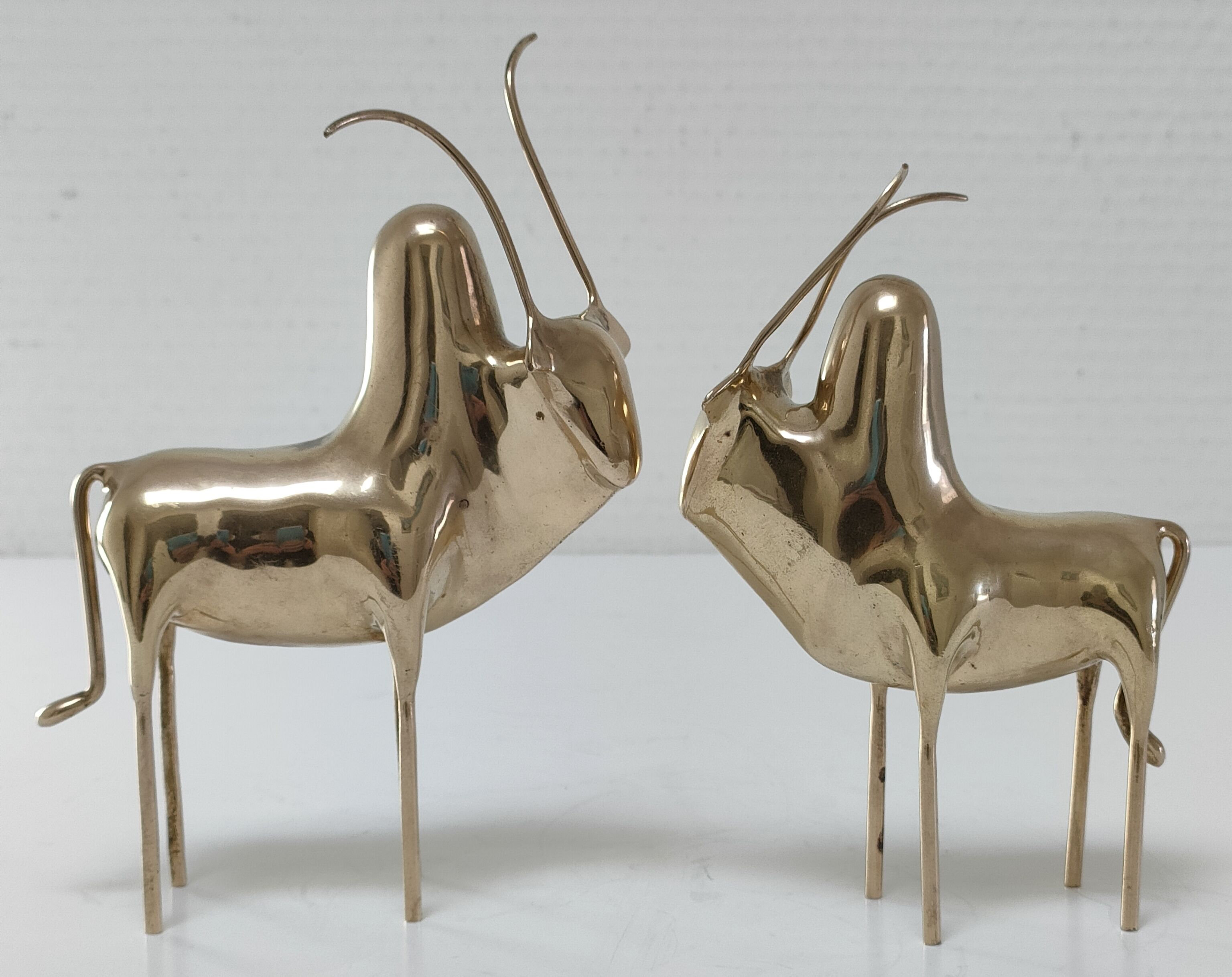 Two stylized zebu with long vintage brass horns