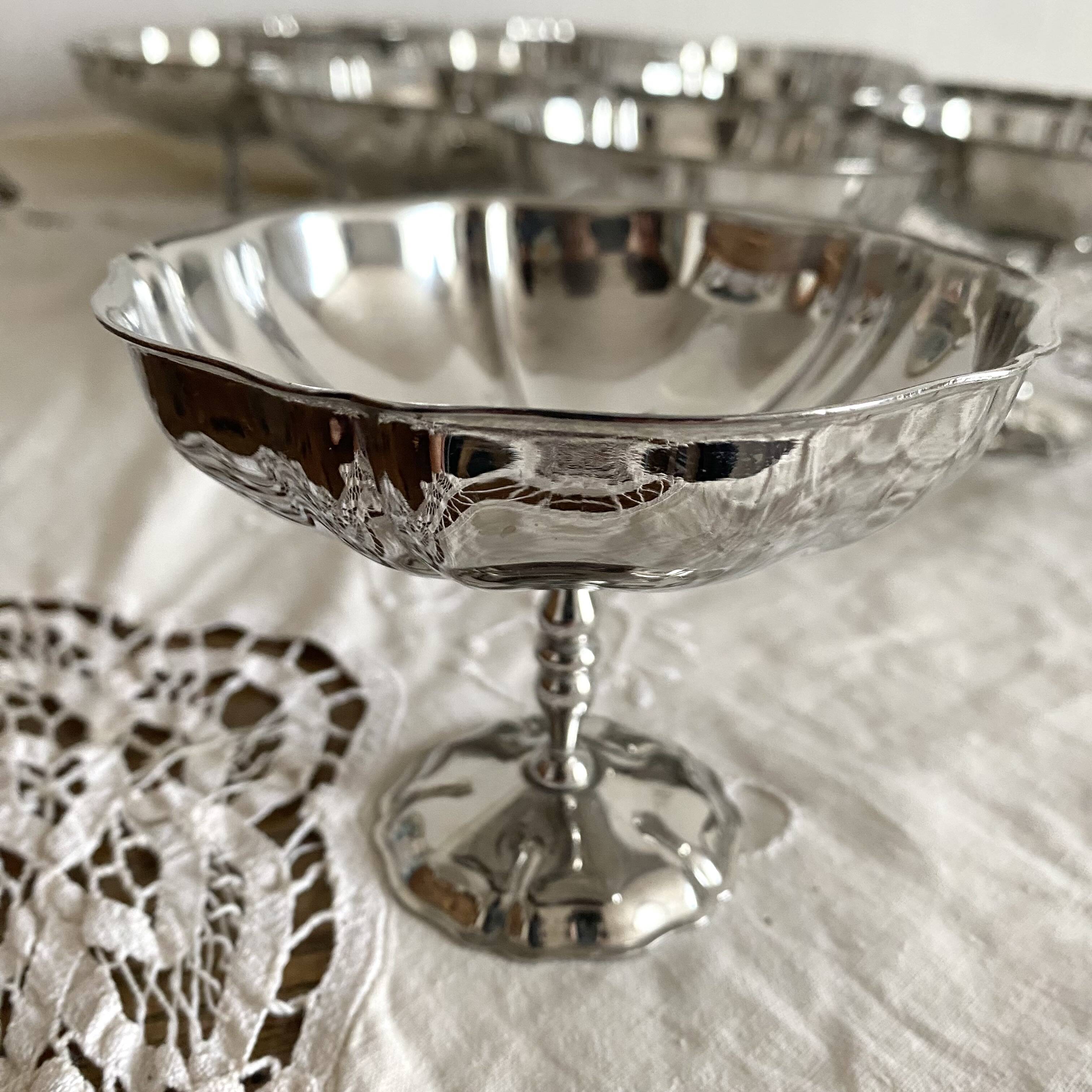 Vintage stainless steel cups on foot